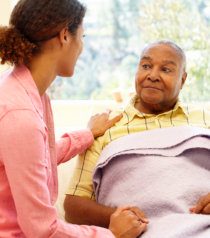 nurse talking to an elderly