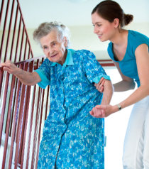 nurse aiding an elderly in the stairs