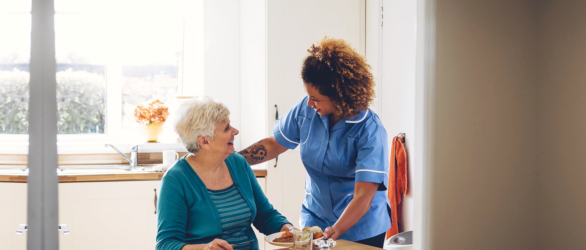 nurse smiling with an elderly woman